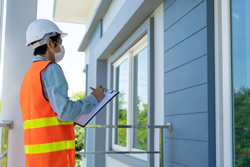 A man is doing inspection of a property before it is available for sale