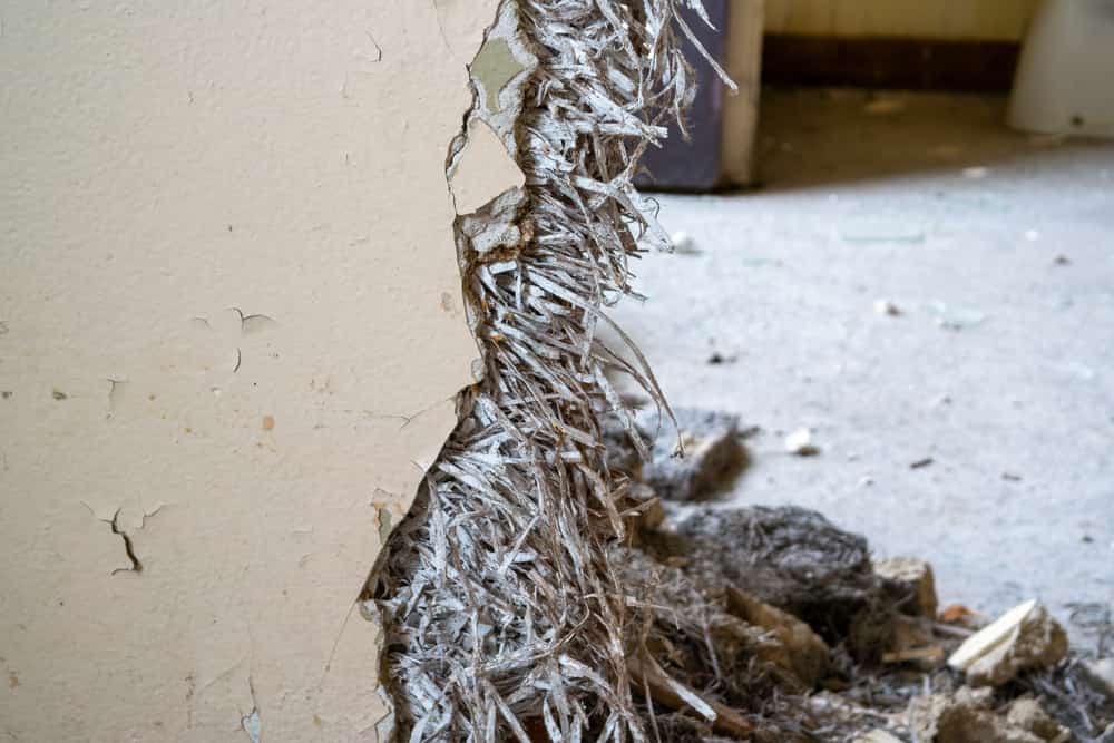 Old asbestos in a wall in the room, harmful to health.